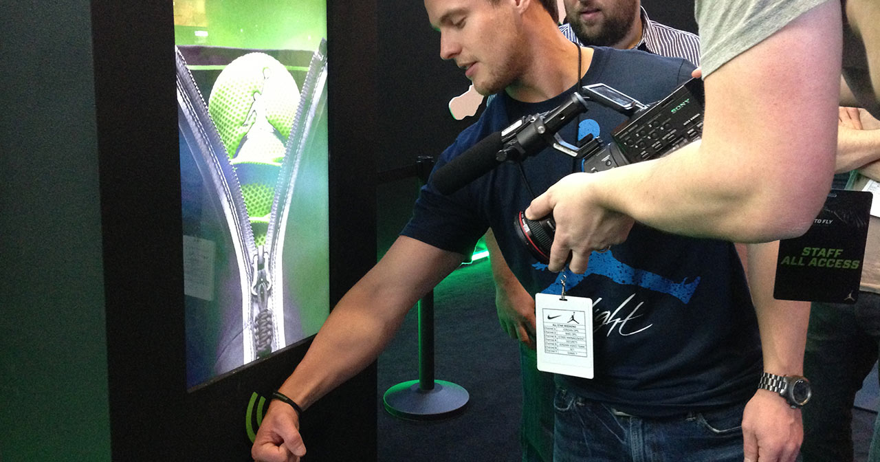 Man scans wristband at kiosk