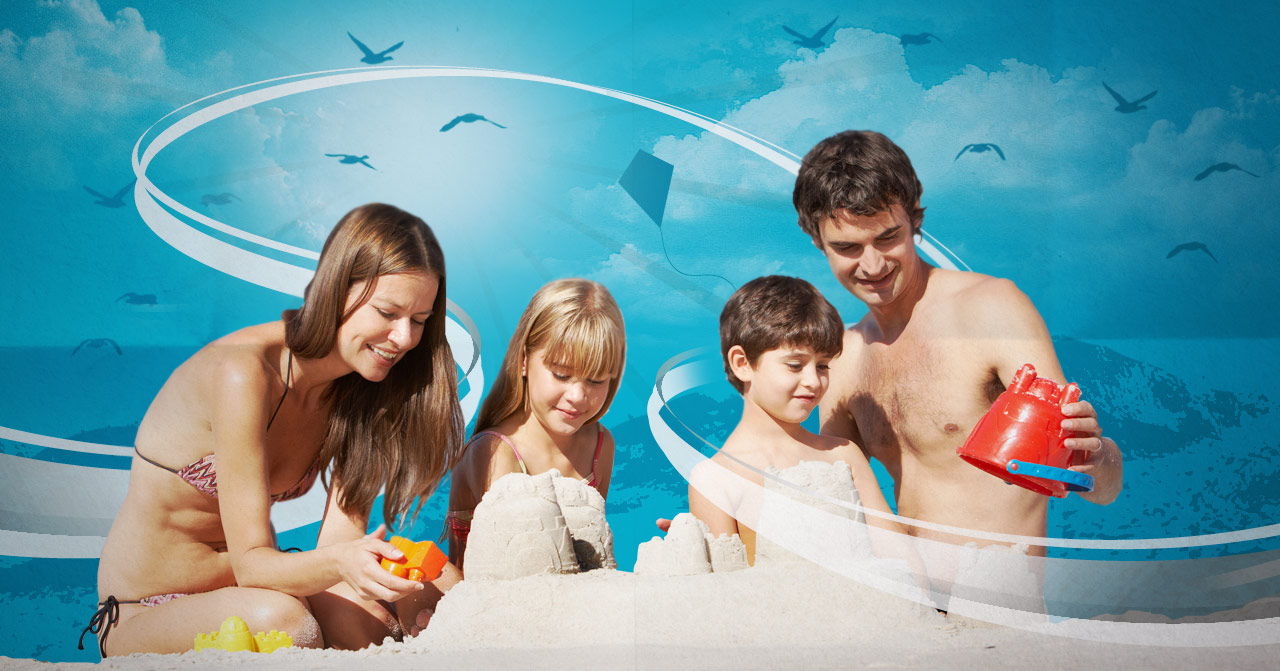 Family of four building a sandcastle at the beach